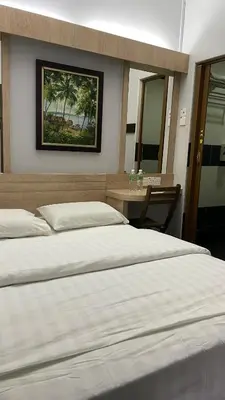 two beds in a bedroom with a picture on the wall at GOPENG INN in Gopeng