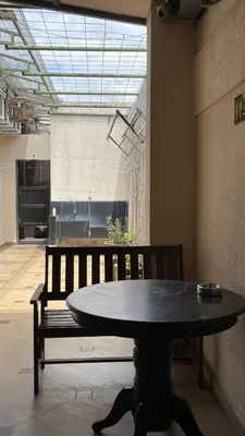 a table and a bench in a room at GOPENG INN in Gopeng