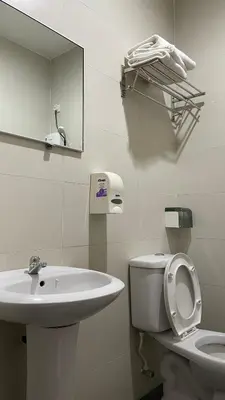 a bathroom with a sink and a toilet and a mirror at GOPENG INN in Gopeng