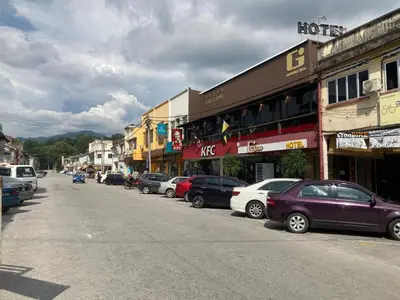 a row of cars parked on the side of a street at GOPENG INN in Gopeng