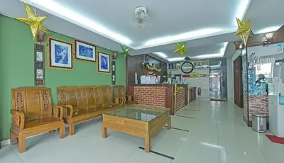 a living room with two benches and a table at GOPENG INN in Gopeng