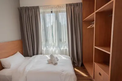 a bedroom with a bed with a large window at Ipoh Tambun Sunway Onsen Suite 3R2B Miya in Ipoh