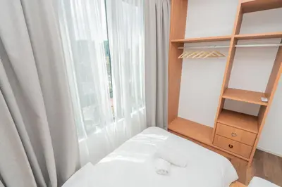 a room with a bed with a window and a shelf at Ipoh Tambun Sunway Onsen Suite 3R2B Miya in Ipoh