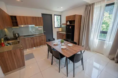 a kitchen with a wooden table and chairs at Ipoh Tambun Sunway Onsen Suite 3R2B Miya in Ipoh