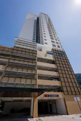 a tall building with a parking garage in front of it at Ipoh Tambun Sunway Onsen Suite 3R2B Miya in Ipoh
