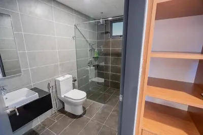 a small bathroom with a toilet and a shower at Ipoh Tambun Sunway Onsen Suite 3R2B Maya in Tambun