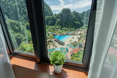 a room with a window with a view of a resort at Ipoh Tambun Sunway Onsen Suite 3R2B Maya in Tambun