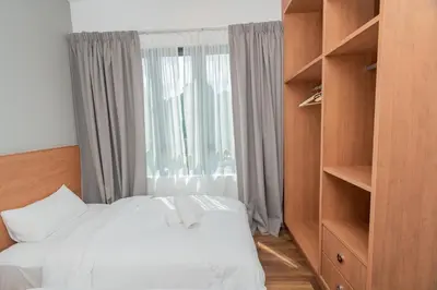 a bedroom with a white bed and a window at Ipoh Tambun Sunway Onsen Suite 3R2B Maya in Tambun