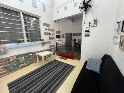 a living room with a couch and a table at Wi-Fi 100MB free Ipoh Town Holiday House Tmn Shatin S36 in Ipoh