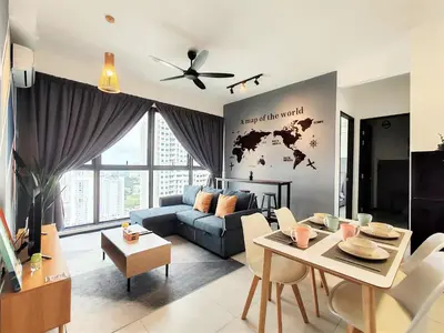 a living room with a blue couch and a table at Cozy Minimalist Suite at Urban Suites Georgetown by SuperStay in Jelutong