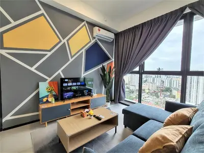 a living room with a blue couch and a tv at Cozy Minimalist Suite at Urban Suites Georgetown by SuperStay in Jelutong