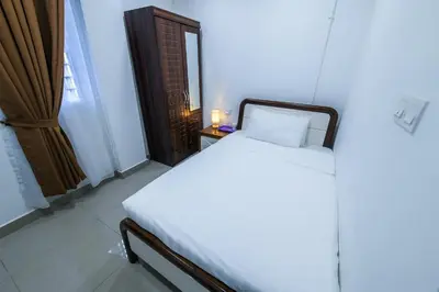a bedroom with a white bed and a window at Capital O 90543 Sp Star Hotel in Sungai Petani