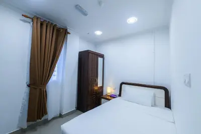 a bedroom with a white bed and a window at Capital O 90543 Sp Star Hotel in Sungai Petani