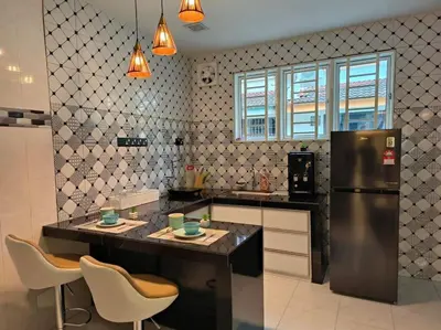 a kitchen with a counter and a refrigerator at (WI-FI) Ipoh Holiday Big House double storey DR8 in Ipoh