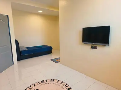a room with a flat screen tv on a wall at (WI-FI) Ipoh Holiday Big House double storey DR8 in Ipoh
