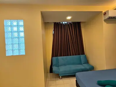 a bedroom with a blue chair and a window at (WI-FI) Ipoh Holiday Big House double storey DR8 in Ipoh