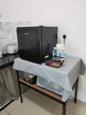 a table with a table cloth on it in a kitchen at ART CASIA HOMESTAY BERTAM in Kepala Batas