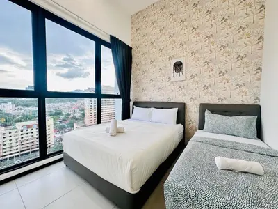 a bedroom with two beds and a large window at New Comfy Urban Suite Homestay at Georgetown for family by Urban Staycations LOD COSY in Jelutong
