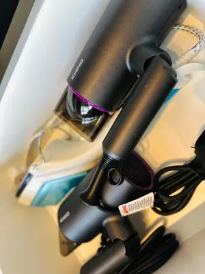 a desk with a hair dryer on a desk at New Comfy Urban Suite Homestay at Georgetown for family by Urban Staycations LOD COSY in Jelutong