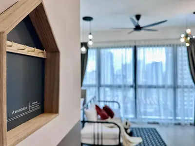 a living room with a chair and a ceiling fan at New Comfy Urban Suite Homestay at Georgetown for family by Urban Staycations LOD COSY in Jelutong