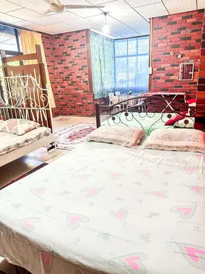 a bedroom with a large bed with pink hearts on it at Dusun Indah Cottage 2 in Bayan Lepas