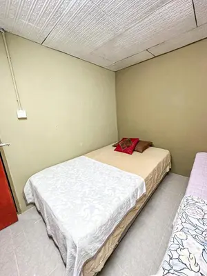 a small bedroom with two beds in it at Dusun Indah Cottage 3 in Bayan Lepas