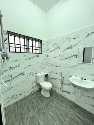 a bathroom with a toilet and a sink at Juzt Homestay Kpg Boyan in Taiping