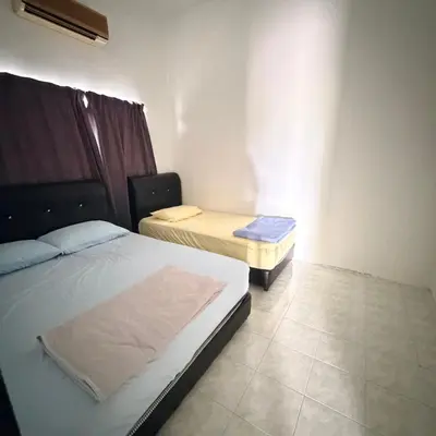 a room with two beds in a room at Juzt Homestay Kpg Boyan in Taiping