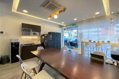 a dining room with a large wooden table and chairs at Sogor Female Dormitory in George Town