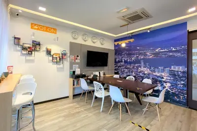 a dining room with a table and white chairs at Sogor Female Dormitory in George Town