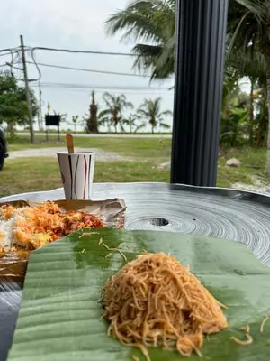 a plate of noodles on top of a banana leaf at ARY&ZZ Homestay for islam guests in Tanjung Karang