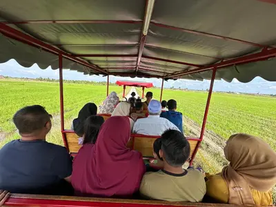 a group of people sitting in the back of a train at ARY&ZZ Homestay for islam guests in Tanjung Karang