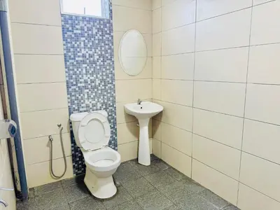 a bathroom with a toilet and a sink at Zaque's Hotel in Sungai Petani