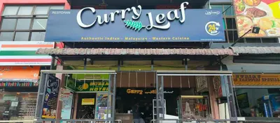 a sign for a curry tofu restaurant on a building at Clock Inn Backpackers Hostel in Tanah Rata