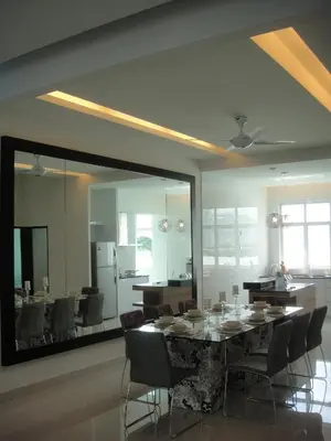 a dining room with a table and chairs and a mirror at Batu Ferringhi - Shamrock Beach Villas, Penang in Batu Ferringhi