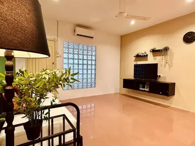 a living room with a couch and a tv and a table at (New) Beachside Antique Villa@14 pax in George Town