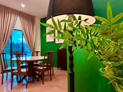a dining room with a table and a green wall at (New) Beachside Antique Villa@14 pax in George Town