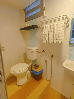 a bathroom with a toilet and a sink at FA House by the Beach in Tanjung Bungah
