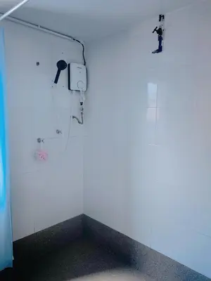a room with a white wall with a speaker on the wall at FA House by the Beach in Tanjung Bungah