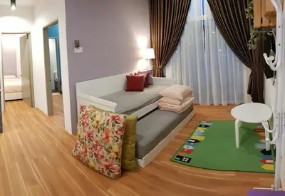 a living room with a couch and a table at G Residence - 2BR Family Suite Barrington Night Market - 3 in Brinchang