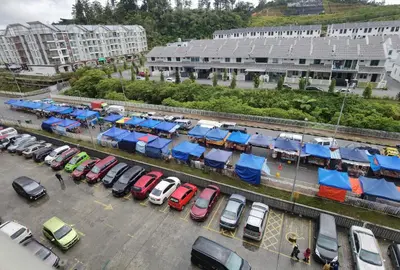 a parking lot with a bunch of cars parked at G Residence - 2BR Family Suite Barrington Night Market - 3 in Brinchang