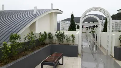a bench sitting on the side of a building at G Residence - 2BR Family Suite Barrington Night Market - 3 in Brinchang
