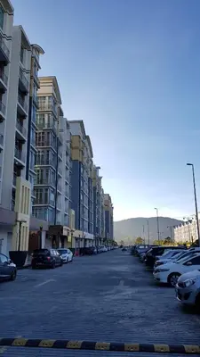 a parking lot with cars parked in front of buildings at G Residence - 2BR Family Suite Barrington Night Market - 3 in Brinchang