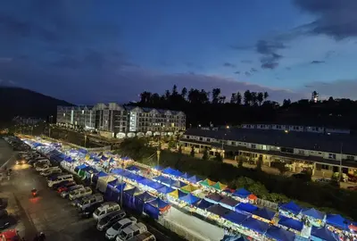 a parking lot filled with blue and white umbrellas at G Residence - 2BR Family Suite Barrington Night Market - 3 in Brinchang