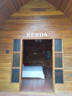 a wooden cabin with a bed in the middle at LBA chalet in Balik Pulau