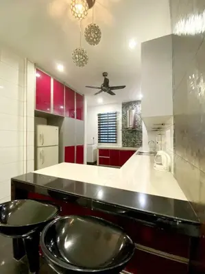 a kitchen with a black counter and red cabinets at CozyHouse 4ROOM 4BATH ROOM 8PAX@Near BM Icon city in Bukit Mertajam