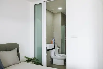 a bathroom with a toilet and a sink at The ELM, 2BR Cityview by W. Stay @ Tropicana 218 Macalister in George Town