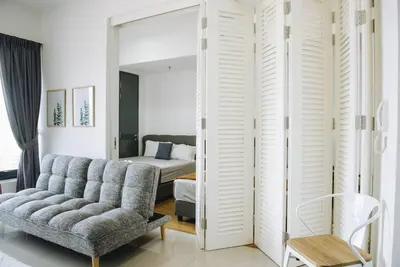 a living room with a couch and a bedroom at The ELM, 2BR Cityview by W. Stay @ Tropicana 218 Macalister in George Town