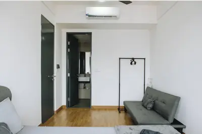 a living room with a couch and a door at The ELM, 2BR Cityview by W. Stay @ Tropicana 218 Macalister in George Town