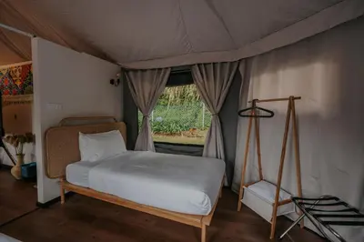 a bedroom with a bed in a tent at Safari Tent with Private Jacuzzi in Brinchang